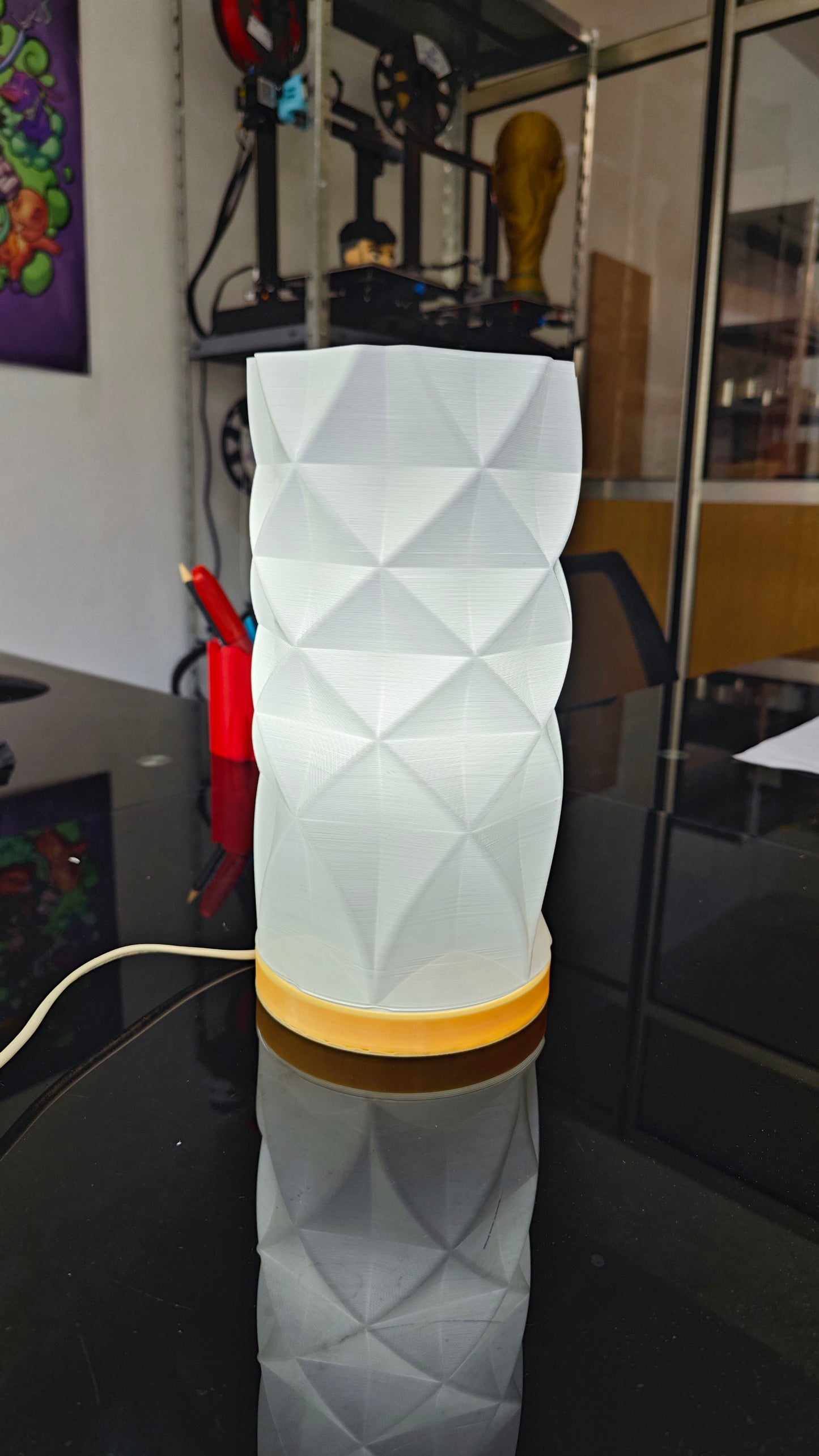a white vase sitting on top of a table