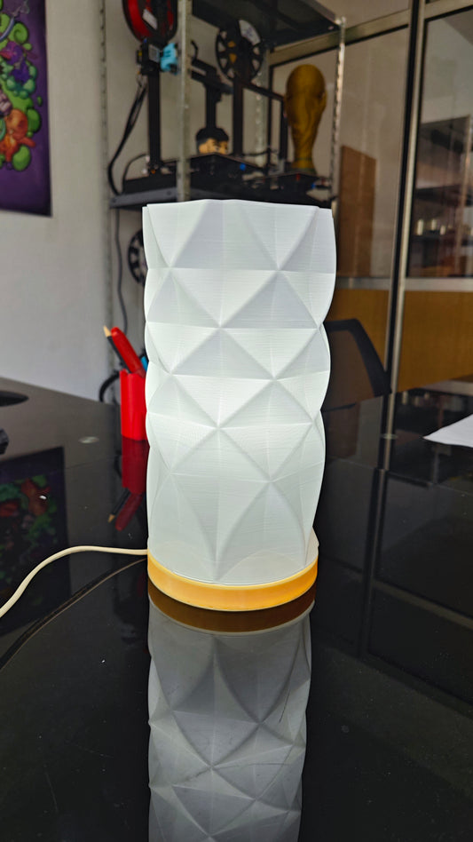 a white vase sitting on top of a table