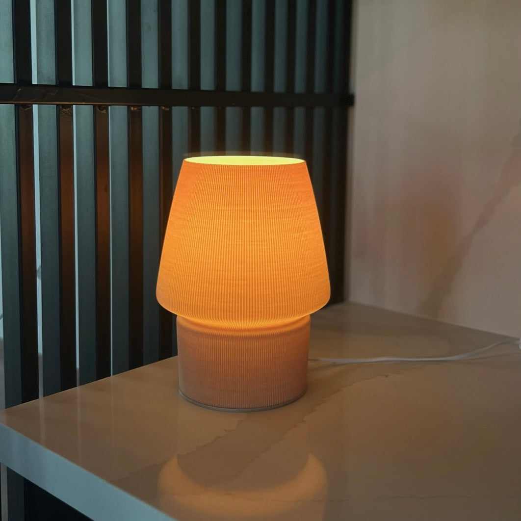 a yellow lamp sitting on top of a table