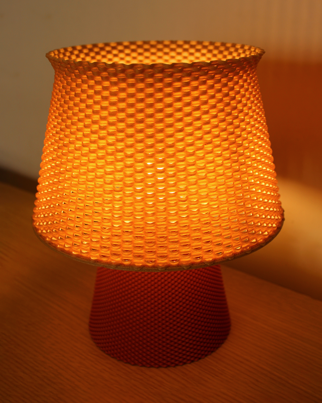 a yellow lamp sitting on top of a wooden table