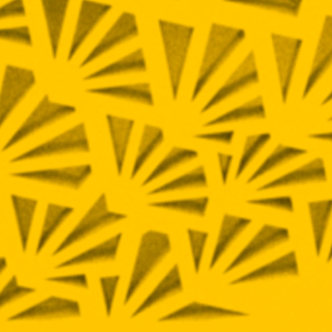 a close up of a yellow paper with a pattern on it