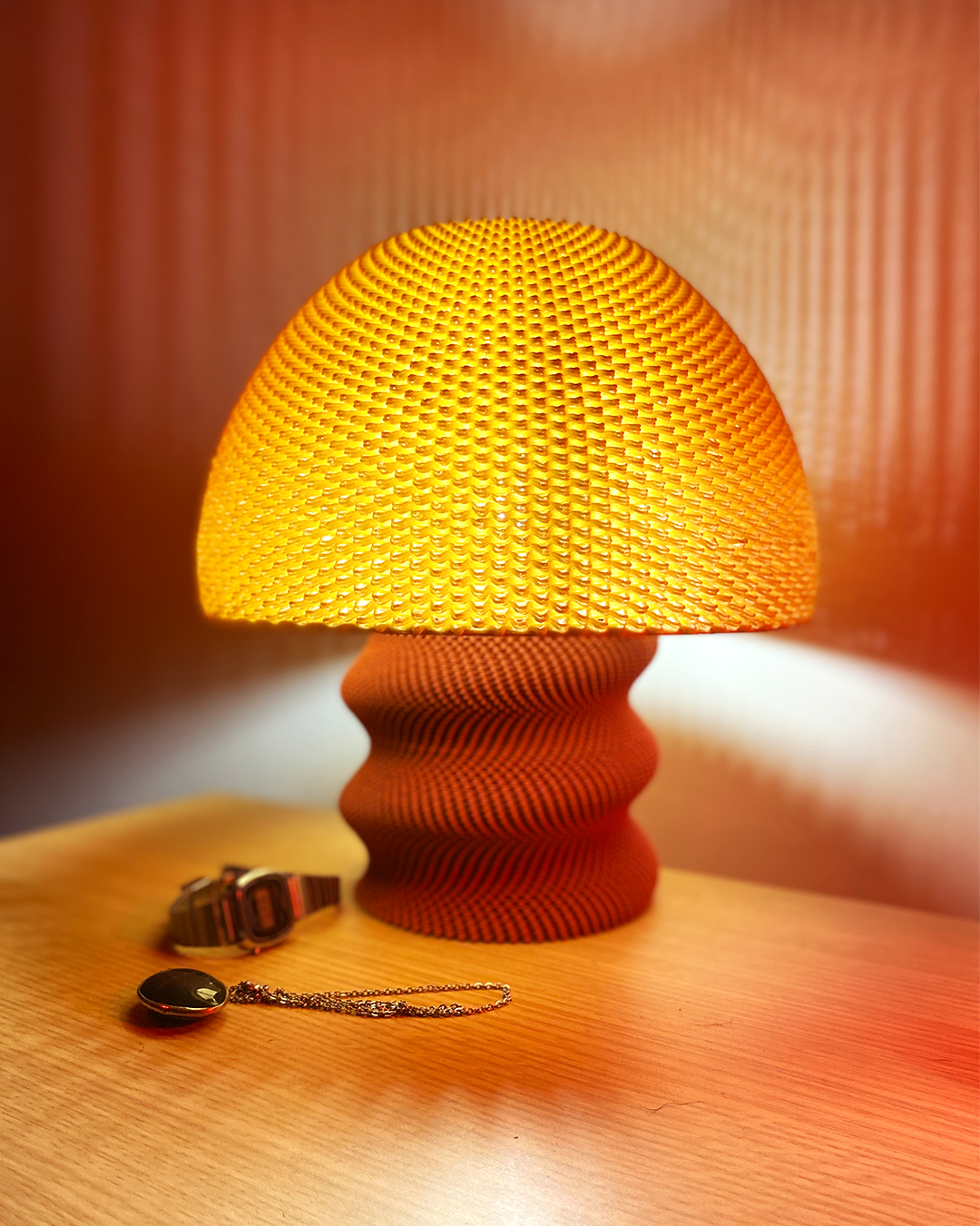 a yellow lamp sitting on top of a wooden table