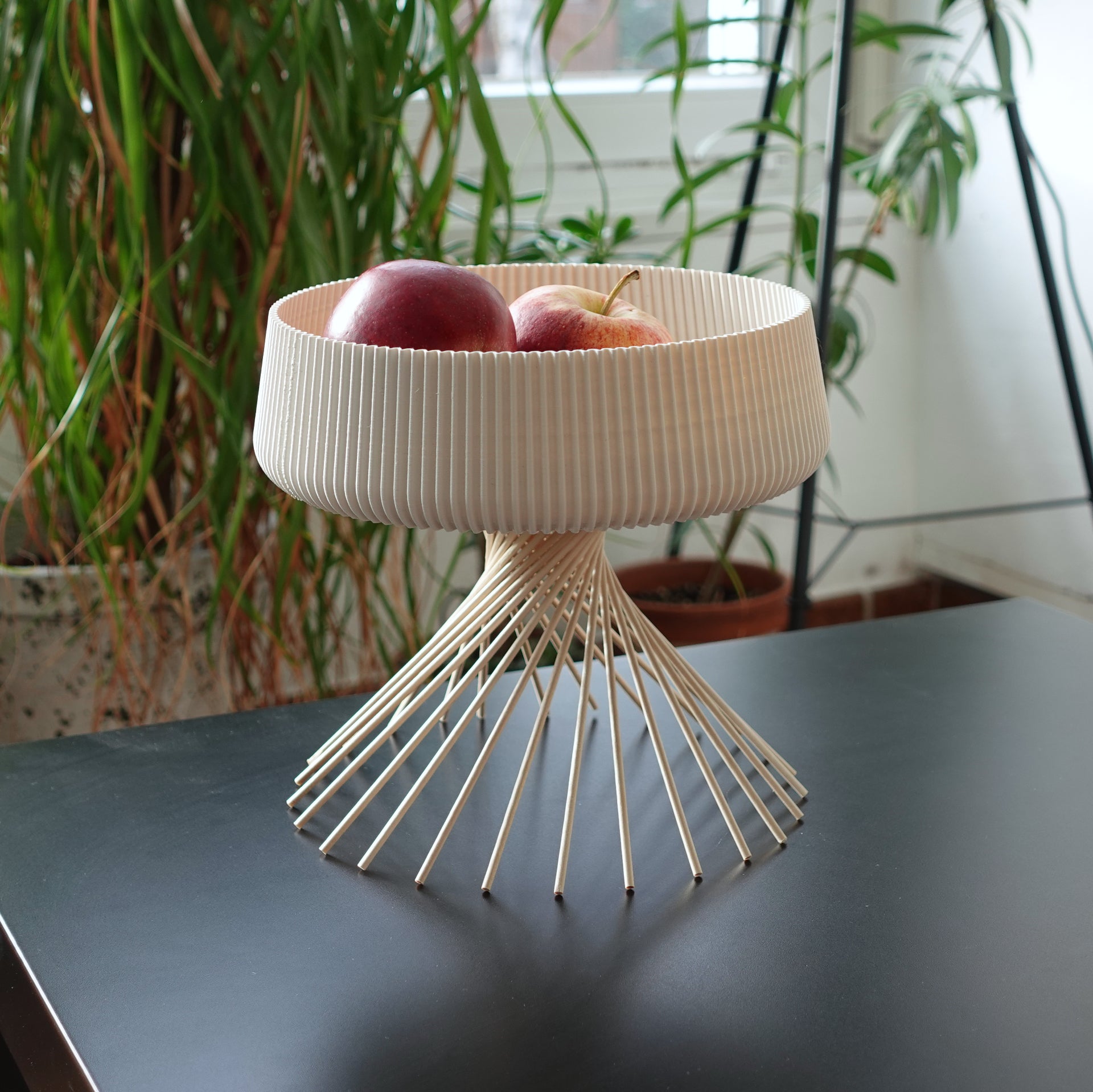 a bowl with two apples in it sitting on a table