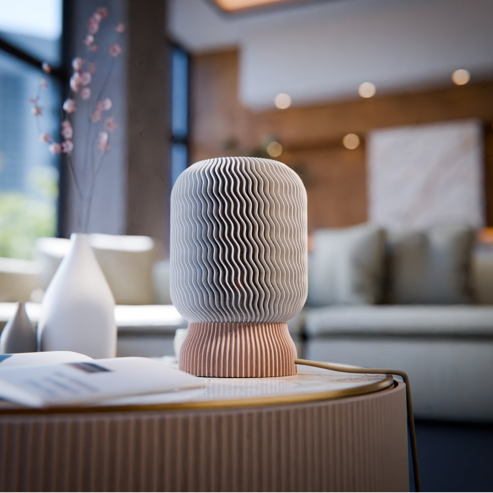 a white vase sitting on top of a table