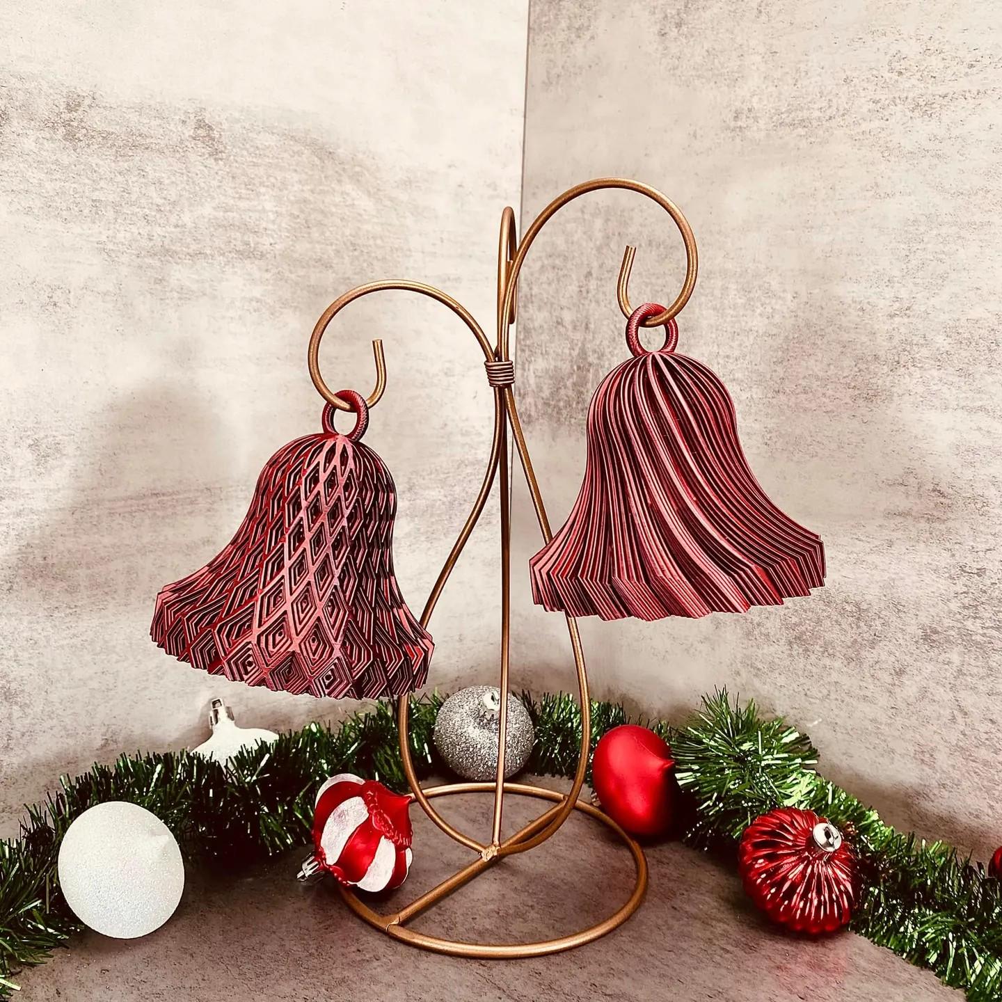a pair of red and white christmas bells on a stand
